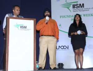 Mr. Bhavesh Singh speaking on th mic on the stage of IISM.